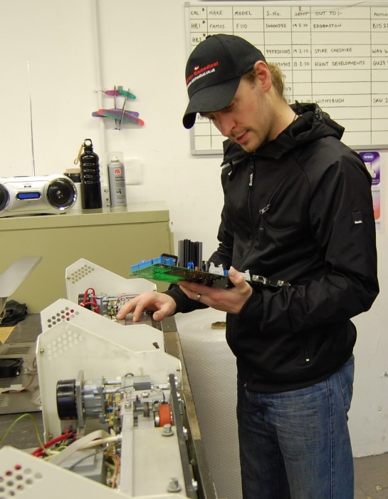 Henderson Biomedical engineer working on a heat sealer