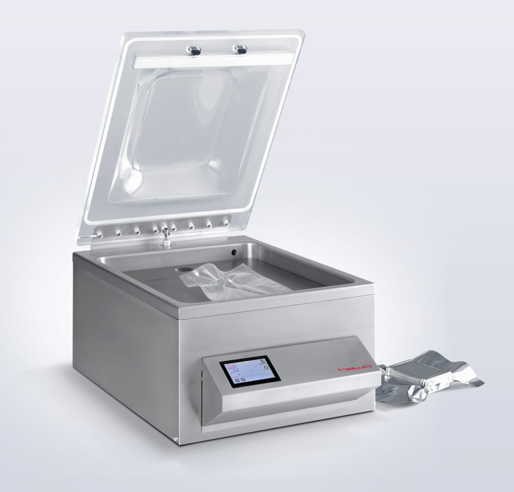 Vacuum chamber sealing machine for use in medical device packaging